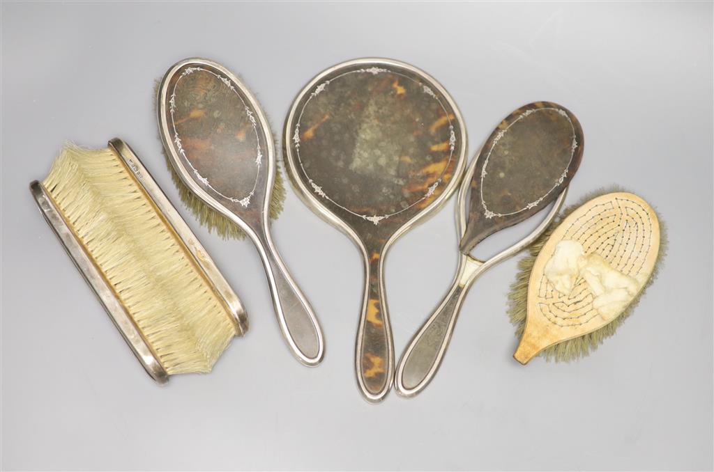 A George V silver and tortoiseshell five piece dressing table set, London 1925 (a.f.).